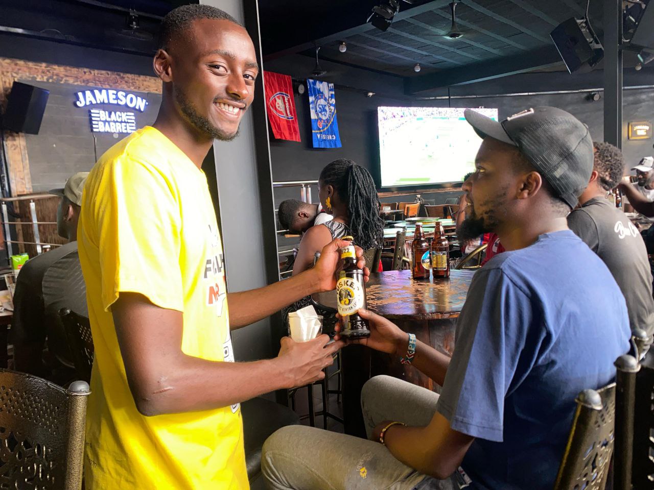 friends-toasting-with-beer-at-sports-bar