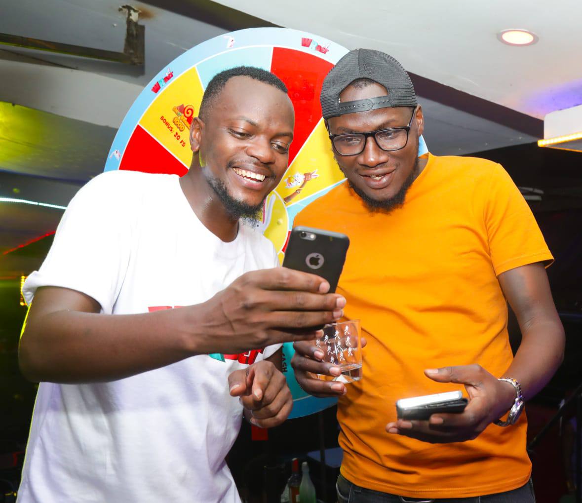 friends-smiling-and-using-smartphone-at-promo-event